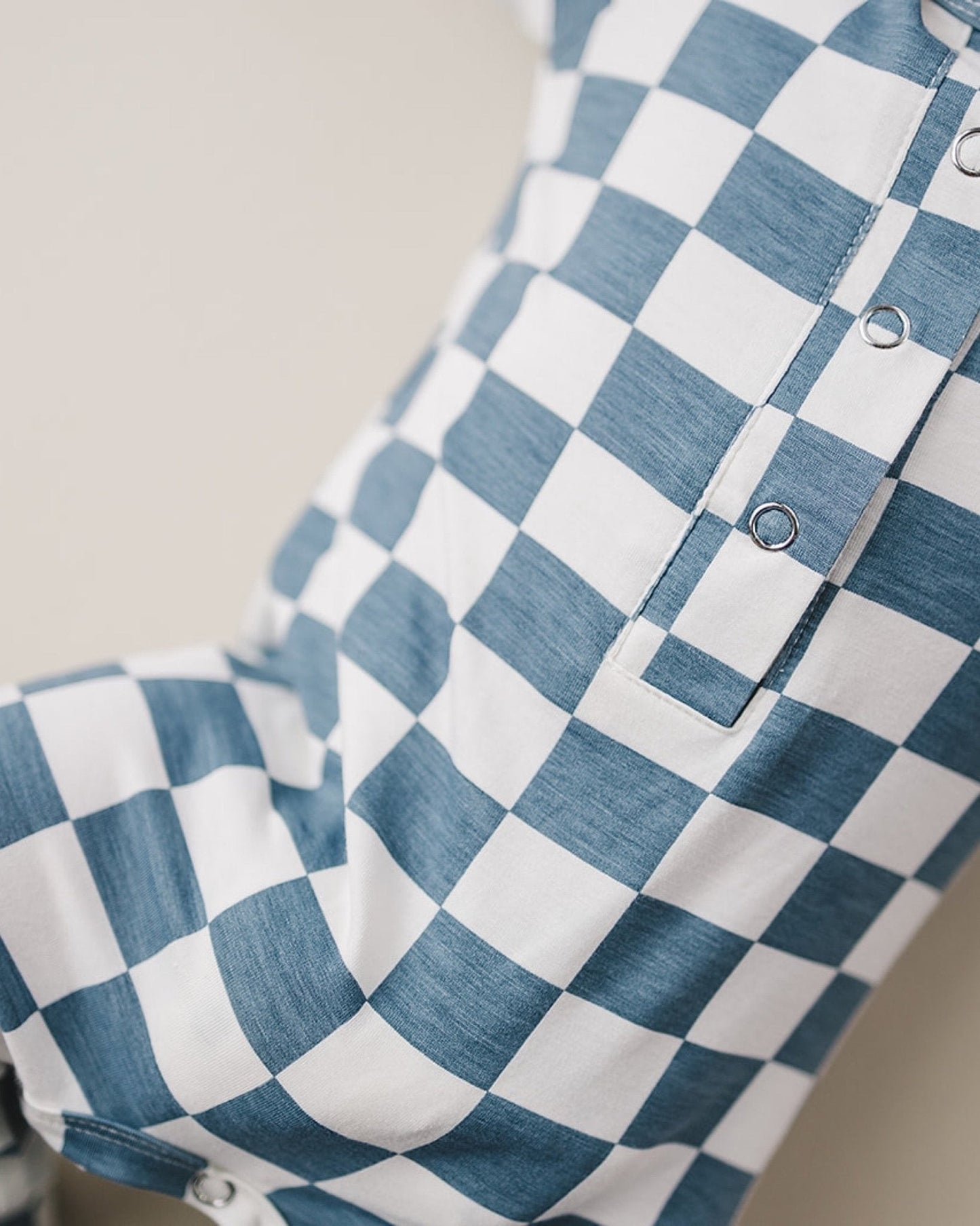 Close up image of blue and white checkered short sleeve bamboo jumsuit from Lucky Panda Kids. Sold by MilkbabyCo