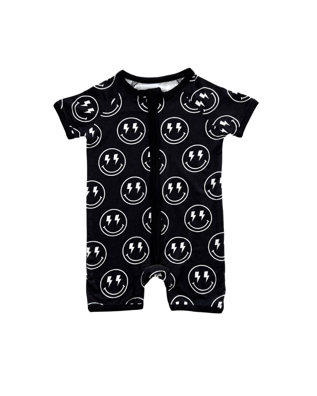 A Lucky Panda Kids black bamboo short sleeved shortie romper with white smiley face designs that have lightning bolts for eyes. Laid out on a white background. 