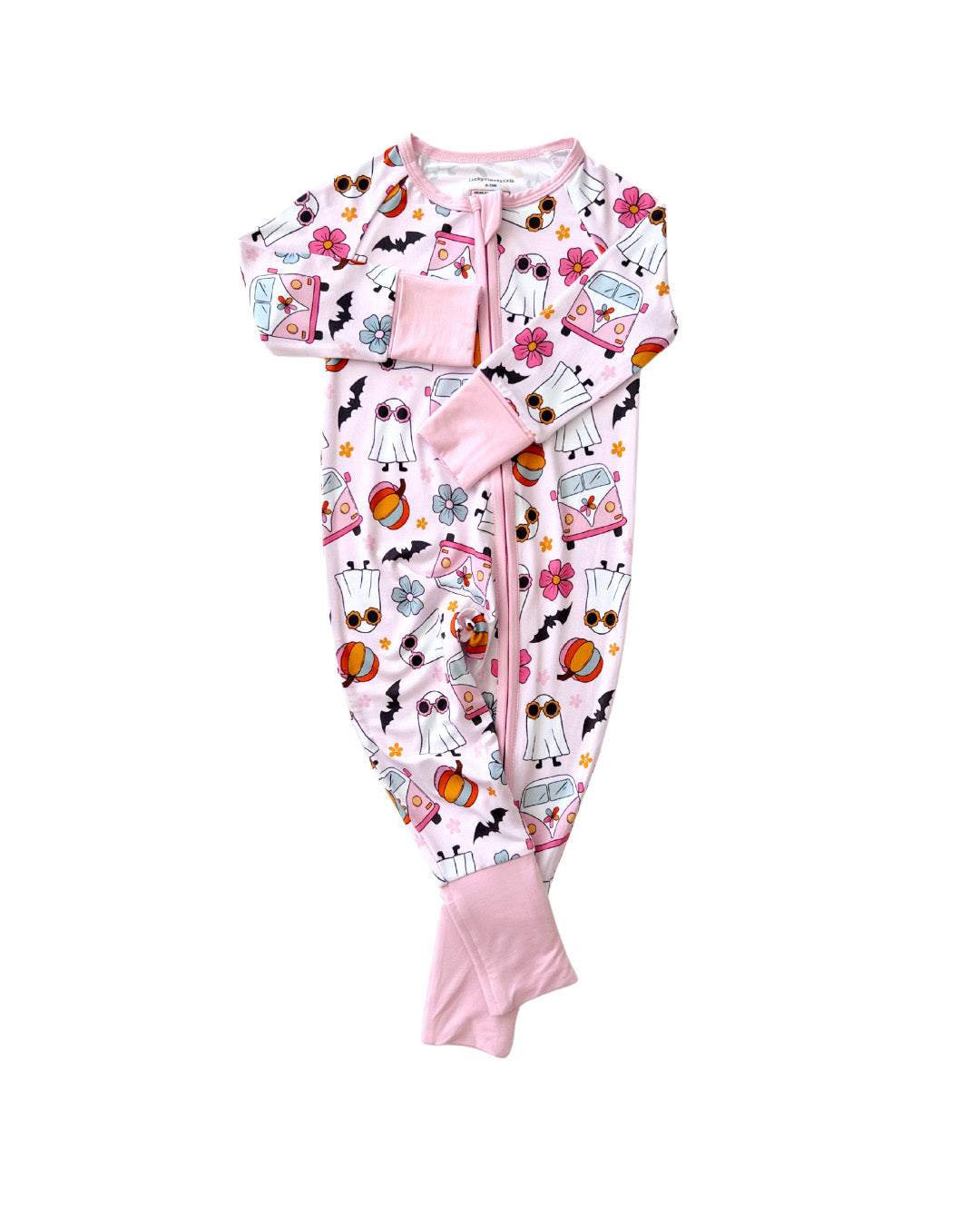 White background with a light pink Lucky Panda Kids zip up pajama in the style of halloween. It has white ghosts, pink hippie vans, multicolored orange pumpkins, blue and pink flowers, and black bats printed on it.